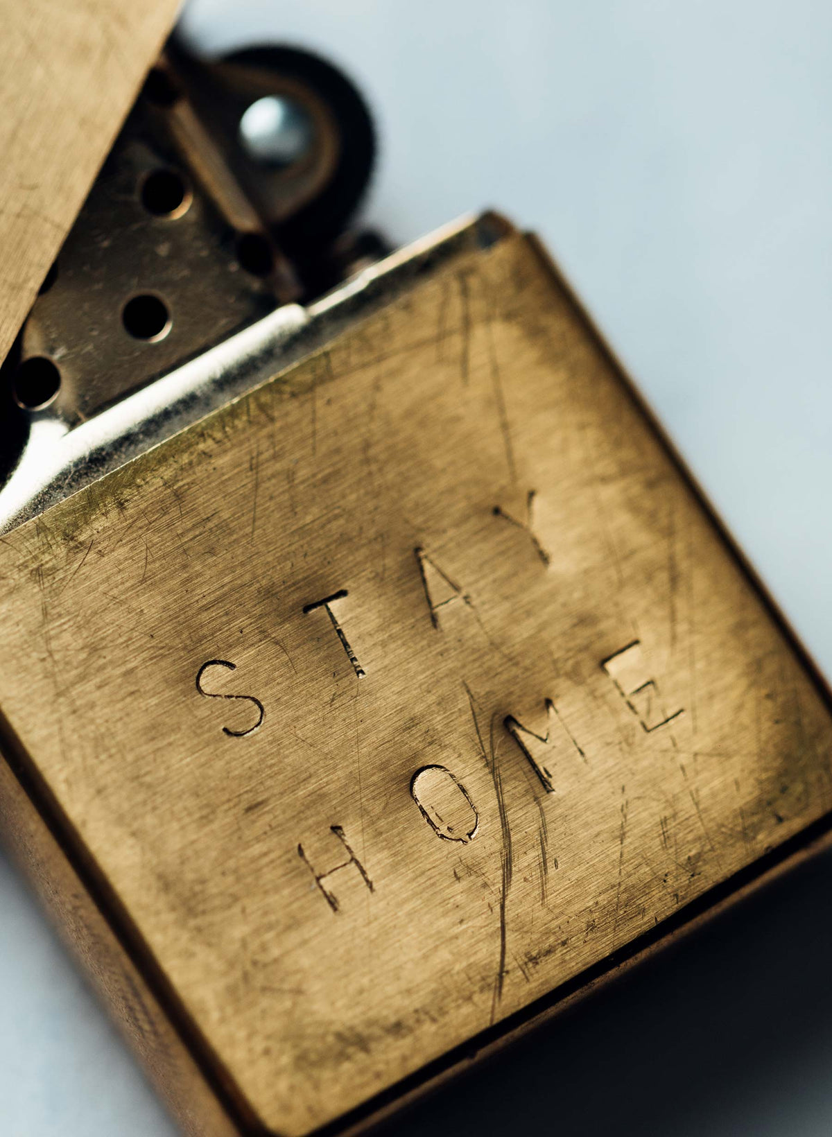 hand stamped “stay home” zippo